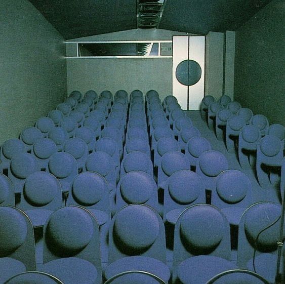 Cool-toned retro-futurist auditorium interior