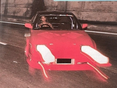 Red Convertible in a Grainy Tunnel